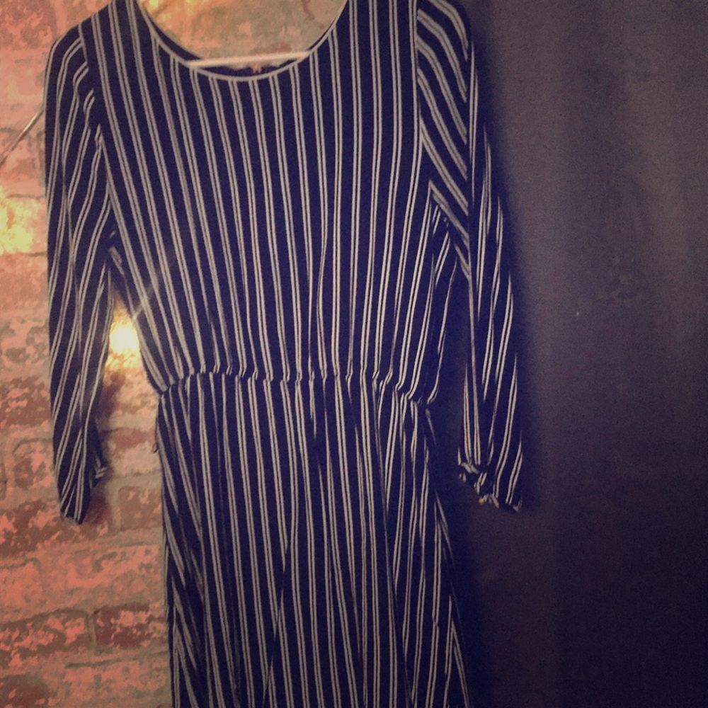 Long-sleeved navy striped minidress, gold buttons.